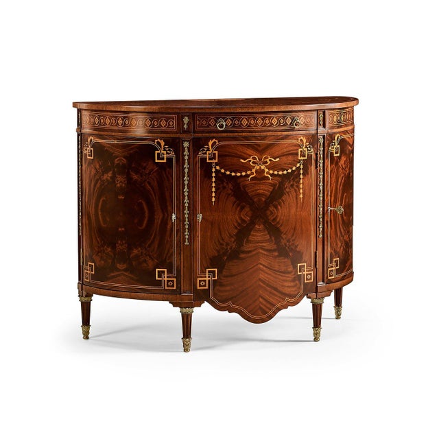 The Adam Style Bow Front Cabinet shows the refined elegance of late Georgian English Neoclassicism, inspired by an...