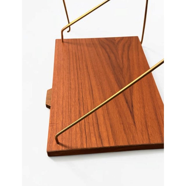 Set of two Danish wall-mounted bedside tables in teak, c. 1960s. A refined Scandinavian Modern design combining compact...