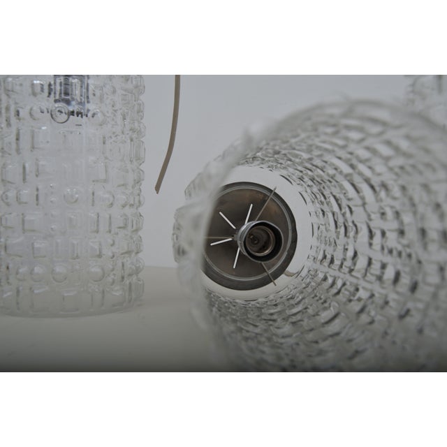 Ceiling light from the 1950s, shaped like a piston with a metal frame. The glass features the typical bubbles and is...