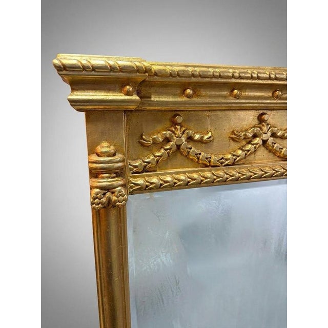 Elevate your space with this elegant Regency style overmantel mirror, featuring a beautifully carved giltwood frame with...