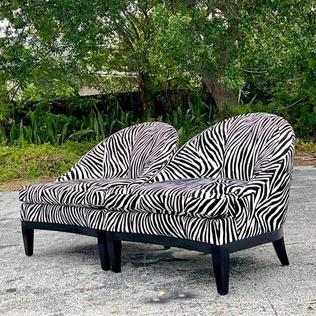 Elevate your living space with this pair of Vintage Boho Low Slung Zebra Lounge Chairs. Featuring a distinctive American...