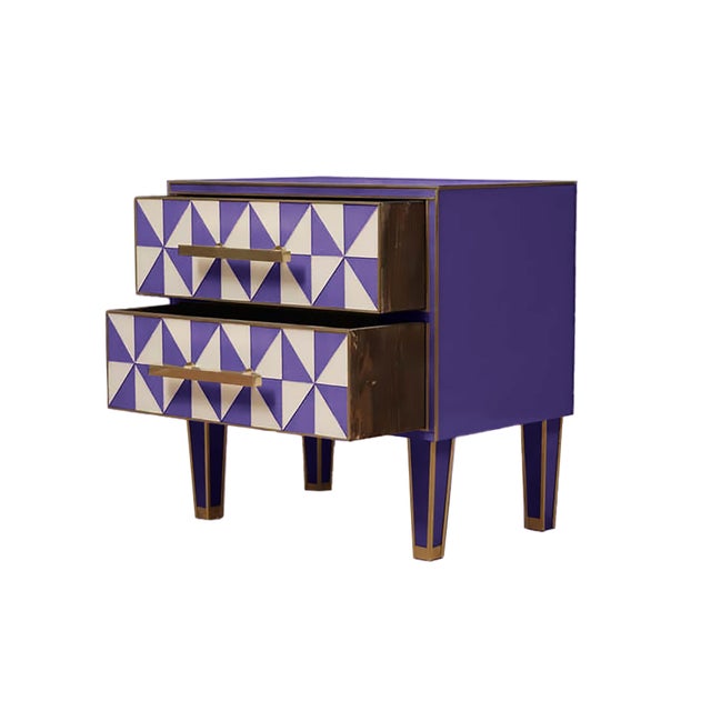 This pair of Italian Murano glass and brass bedside tables, featuring a striking “optical effect” in purple and white, is...