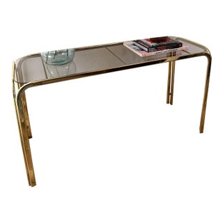 Hollywood Regency Brass Console Table With Smoked Glass Top and Waterfall Edges For Sale