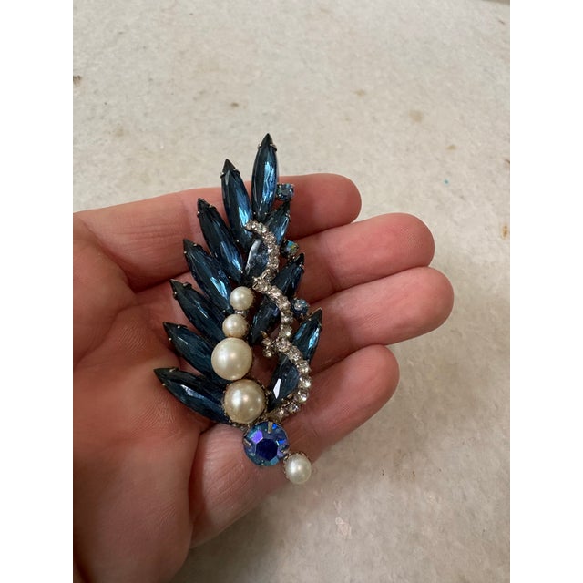 Stunning vintage blue rhinestone with faux pearls and details.