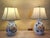 Pair of vintage ceramic lamps decorated with hand‑painted orange flowers, green foliage, and blue accents, paired with...