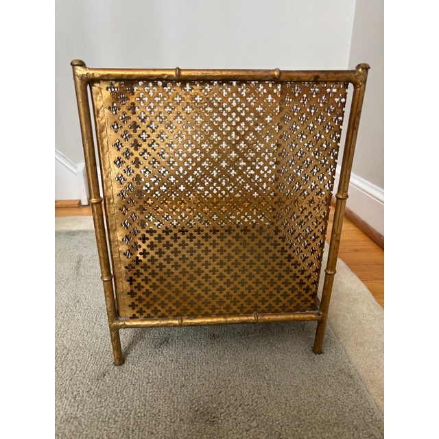 A Gilt Metal Waste Can with a faux bamboo frame and button feet enclosing pierced gilt metal sides with a quatrefoil...