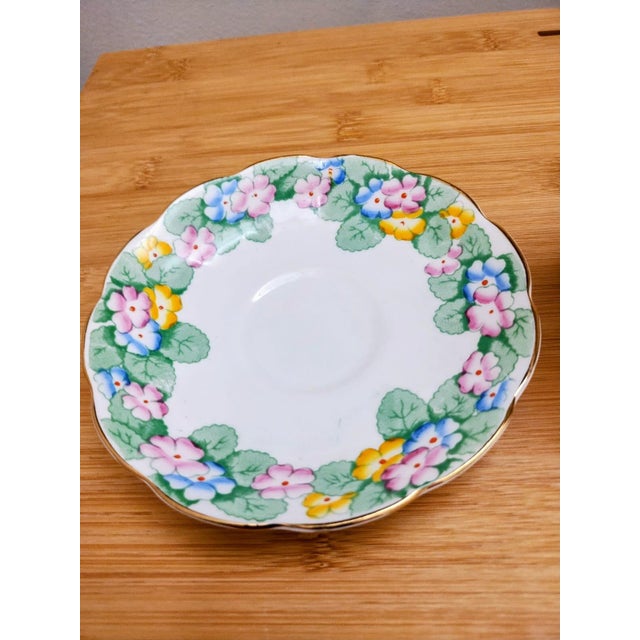 Royal Albert Crown China English tea set, consisting of a "Primrose" teacup and saucer enhanced with hand painted detail...