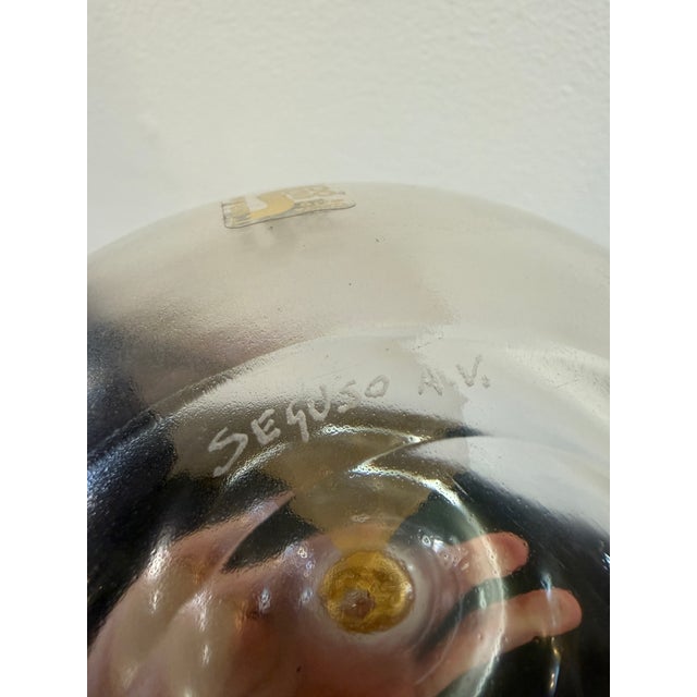 An elegant Murano glass apple by Seguso, exemplifying the refined artistry of Venetian glassmaking. The piece features a...