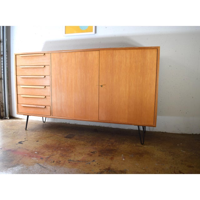 This sideboard is a WK Möbel original from the 1960s. The cabinet features a high-quality oak veneer. The veneer was...