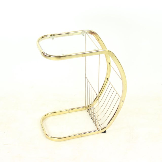 An unusual Modernist side table with integrated magazine rack, most likely produced in Italy during the 1970s. The...
