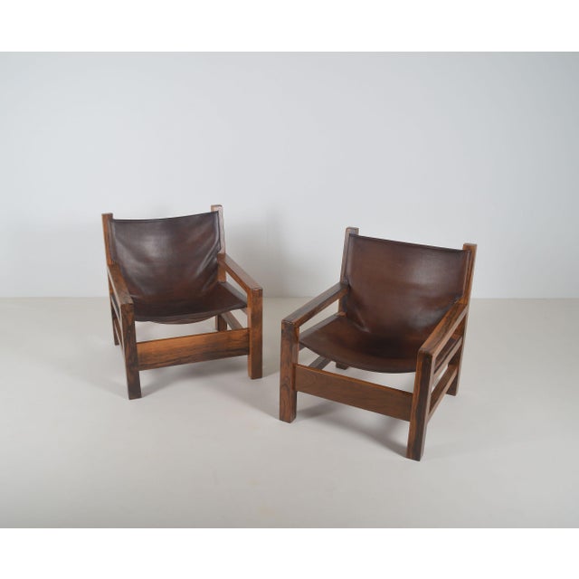 A set of armchairs from France, made in the 1970s. These armchairs have a beautiful olive wood frame with a brown saddle...