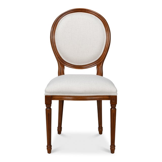 Warm, open-grained walnut surrounds the oval back associated with Louis XVI seating. Cream upholstery fills the oval and...