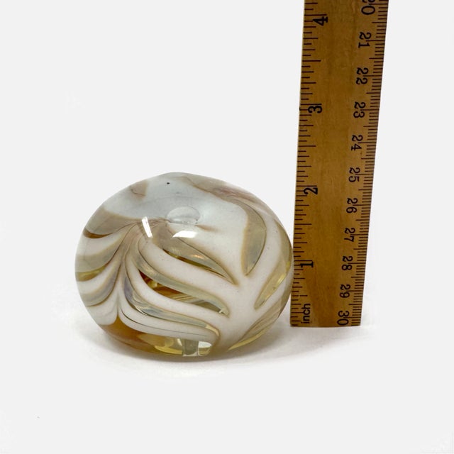 Add a beautiful piece of vintage studio glass to your collection with this 1979 art glass paperweight by renowned artist...