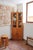 A glazed bookcase in solid pine, French rustic-modernist in the manner of Maison Regain. Two glazed doors above over four...