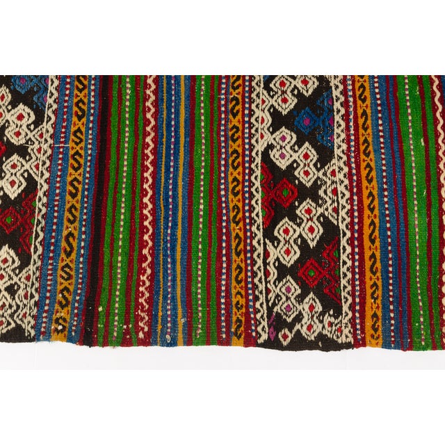 This is a vintage Turkish Oushak rug from the Mid 20th Century. The piece was hand-knotted.