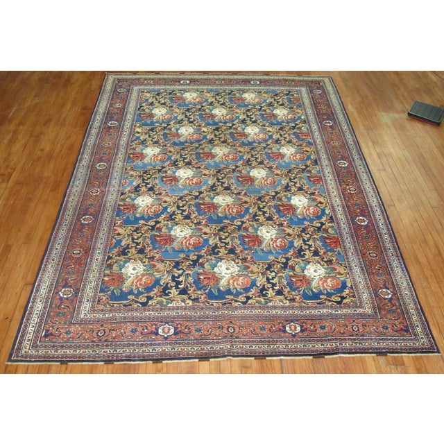A 20th century room size Persian Bidjar rug with an all-over floral design on a navy field. Accents in blue, light green,...
