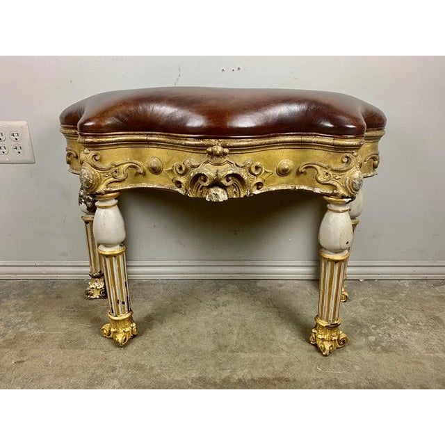 Custom serpentine shaped bench made with antique Italian painted and parcel gilt fluted legs with capital feet. The bench...