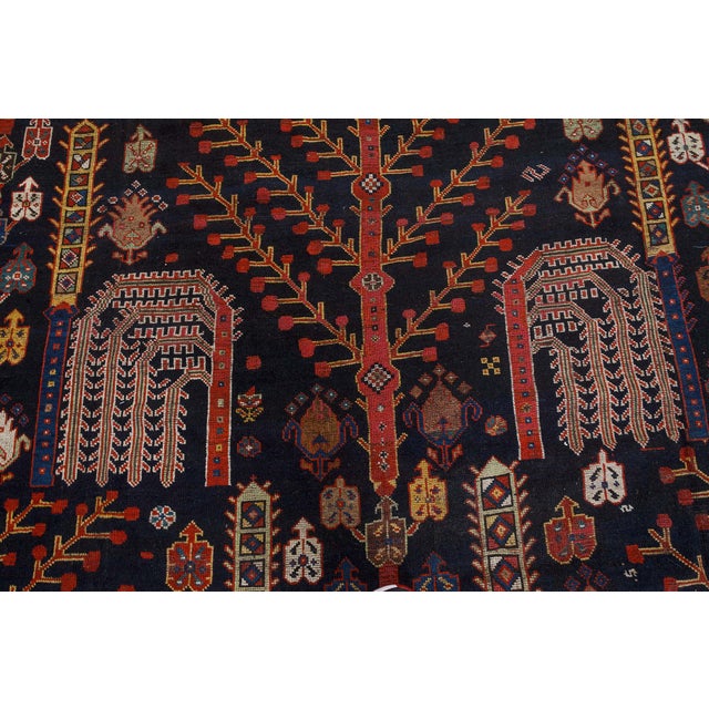 A late 19th century Persian Bakhtiari antique rug, the black field with a bold geometric floral design of angular branches...