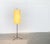 Simple Mid Century floor lamp with striking Tripod foot. A minimalist design. The screen shows a simple cylindrical shape...