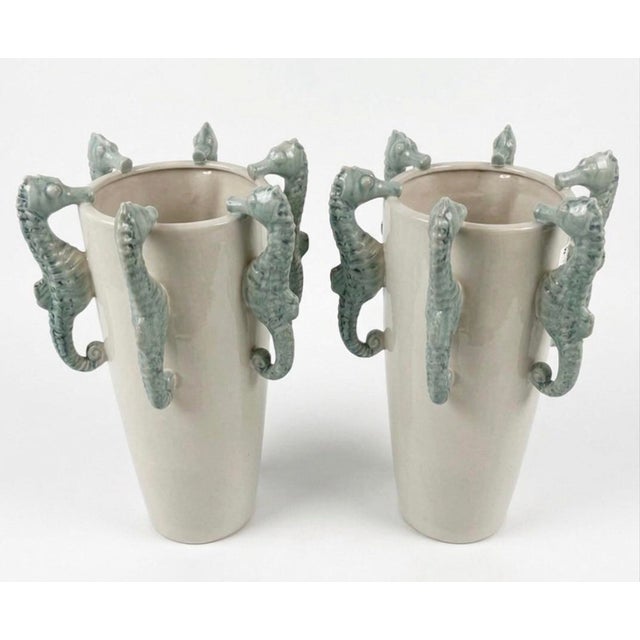 This striking pair of vintage ceramic vases captures a playful yet sophisticated coastal elegance. Each tapered vessel is...