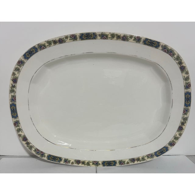 This vintage platter is an American antique made by the Edwin M. Knowles China Company. The backstamp features the...