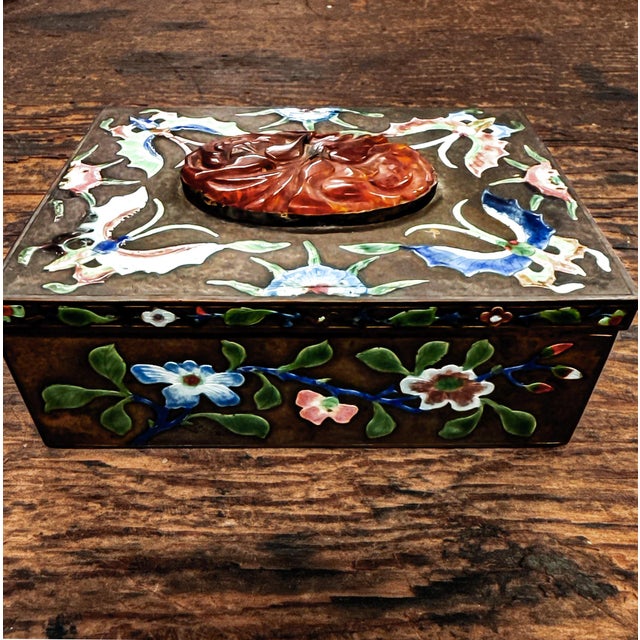 A carved Chinese jade and enamel cloisonne hinged metal box featuring intricate cloisonne detailing with enamel and jade...