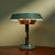 This table lamp, crafted by an Italian manufacturer during the 1950's, showcases a harmonious blend of industrial design...