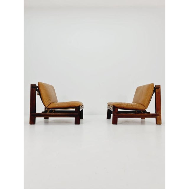 1 of 2 mid century armchairs in leather and wood By Carl Straub Germany , 1960s The beautiful armchair is comfortable and...
