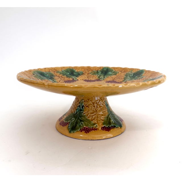 This glazed and embossed German Majolica taza or cake stand features hand-painted grape leaves and purple wine berries. Of...