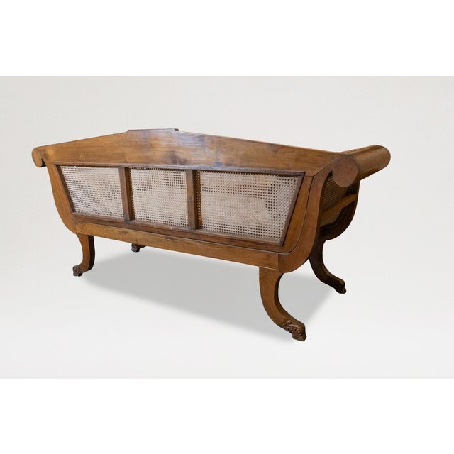 The straight back inset with three cane panels set below a reeded crest rail centered by an ovoid panel; with caned...