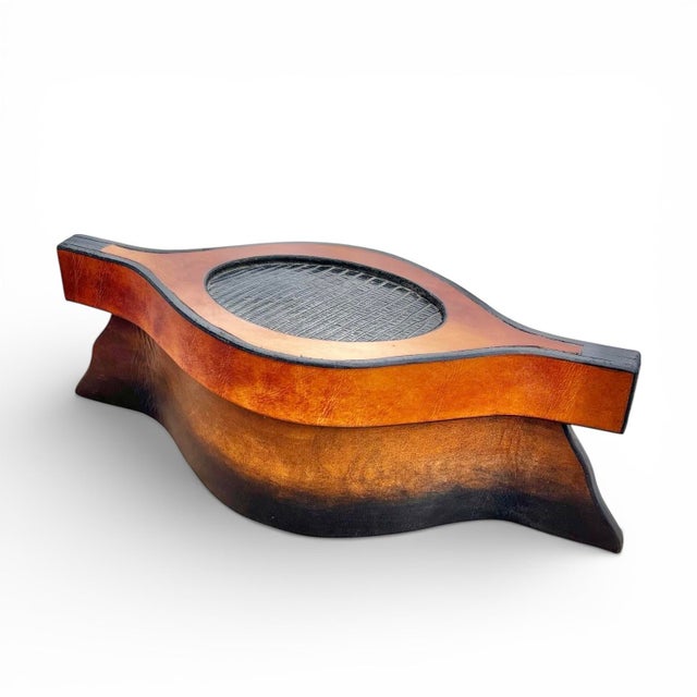 A interesting handmade oblong leather box or container. Beautiful variation in colors and patina, with a textured leather...