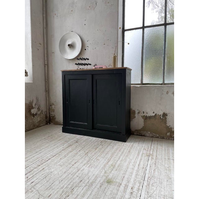 Old small pine furniture with sliding doors. this piece of furniture is made up of two sliding doors topped with metal...