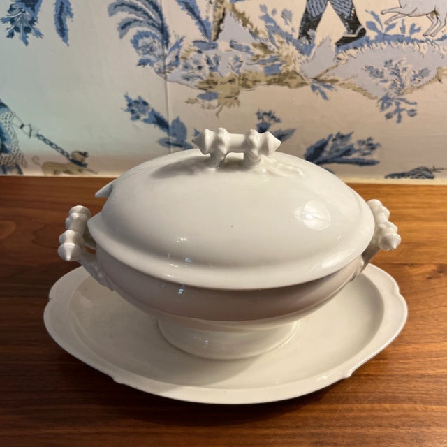 A small antique white ironstone sauce tureen with lid and attached base. Marked H & Co.