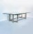 Elegant vintage coffee table with an all-glass top and a polished steel frame featuring distinctive geometric interlacing...