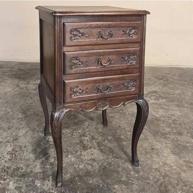 A refined 19th century French walnut petit commode fashioned in the graceful Louis XV tradition. Its beautifully carved...