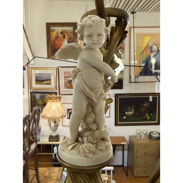 Design Plus Gallery presents a Antique Art Nouveau Four Light Chandelier. A metal frame with frosted glass floral shades...