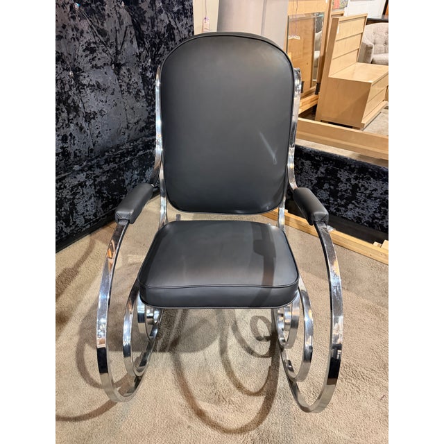 Boldly sculptural and effortlessly modern, this chrome and black leather rocking chair makes a striking statement with its...