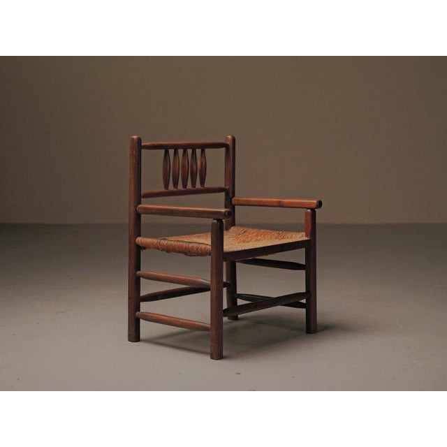 Solid wood armchair presents an interesting balance between modernist restraint and rural tradition. The structure,...