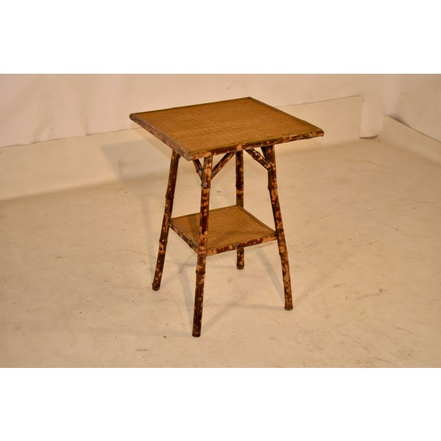 Late 19th century tortoise bamboo side table with a rush covered top and lower shelf. This is a lovely side table from...