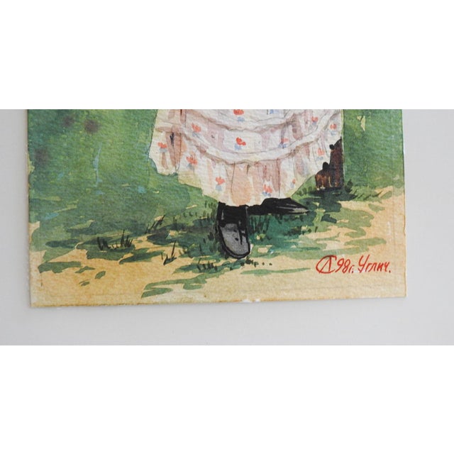 Late 20th century watercolor on paper painting of woman in 19th century dress leaning on old split rail fence. Signed...