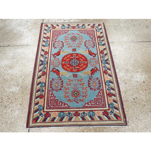 A vintage East Turkestan Khotan throw rug handmade during the Mid-20th Century. Measures: 2' 7" x 3' 10".