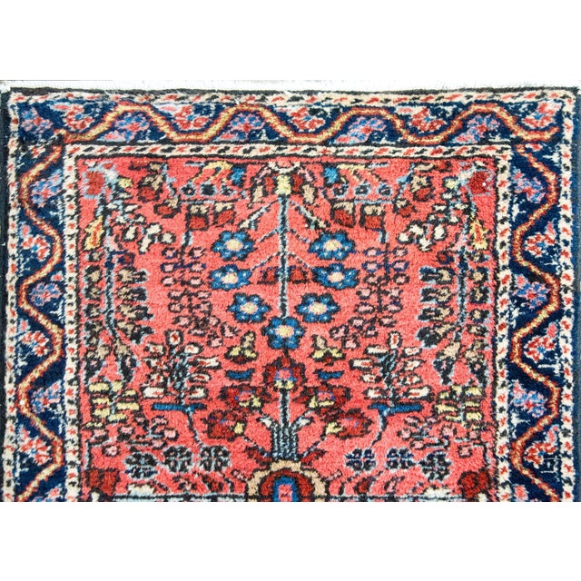 A striking early 20th century petite Persian Sarouk rug with a mirrored floral pattern with myriad varieties and clusters...