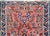 A striking early 20th century petite Persian Sarouk rug with a mirrored floral pattern with myriad varieties and clusters...