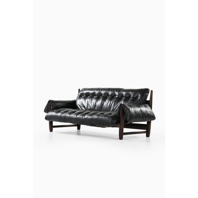 Sofa in ironwood and leather by sergio rodrigues, 1957 additional information: material: ironwood and leather style: mid...