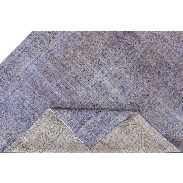 Beautiful vintage Persian distressed hand-knotted wool rug with a purple field. This piece has a brown frame and gray...