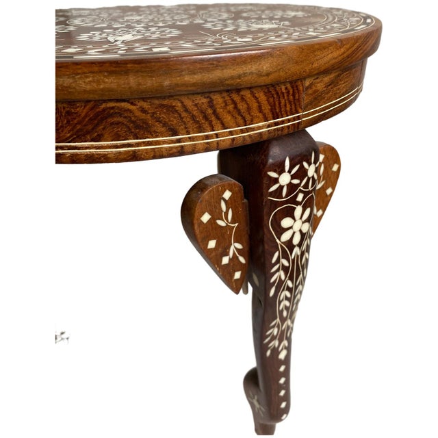 1970s Anglo-Indian carved teak side table, featuring intricate hand-carved elephant and peacock motifs with bone inlay...