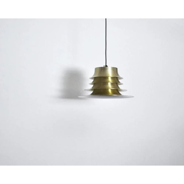 A classic Danish multilayered pendant in brass with white enamelled inner surface. Probably by Nordisk Solar. Dimensions:...