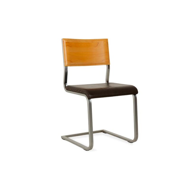 The Wöstmann chair set is upholstered in brown genuine leather and sits on a narrow metal frame. The backrests are made of...