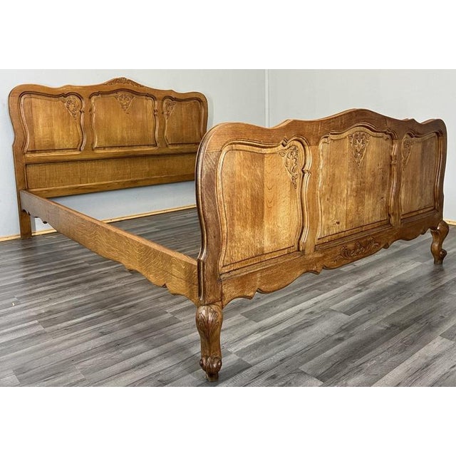 This elegant Vintage French Louis double bed frame features refined carved detailing and softly flowing contours, making...