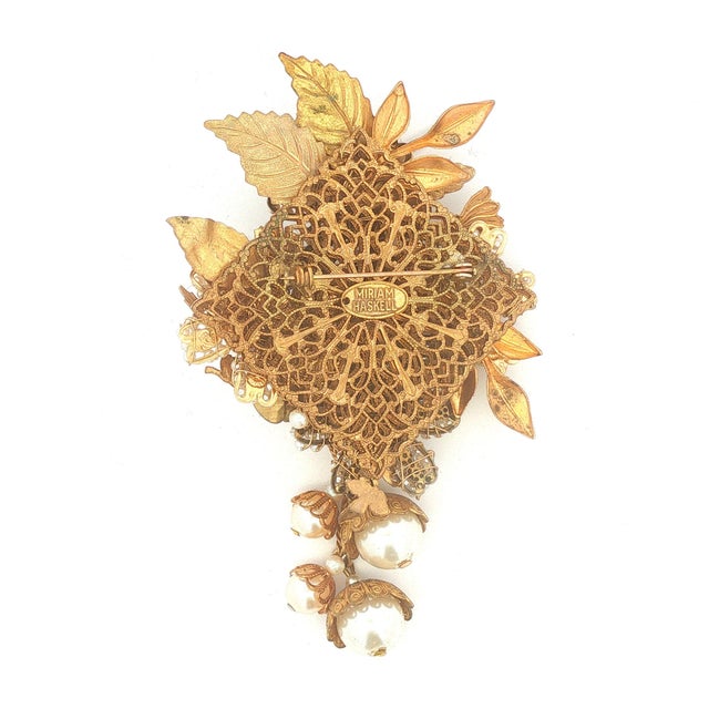Another fabulous vintage floral brooch by Miriam Haskell. This features faux pearls hand-wired and rhinestone accents....